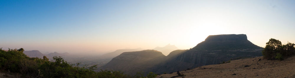 Scenic view of mountains against clear sky during sunset