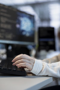 Cropped hand using laptop