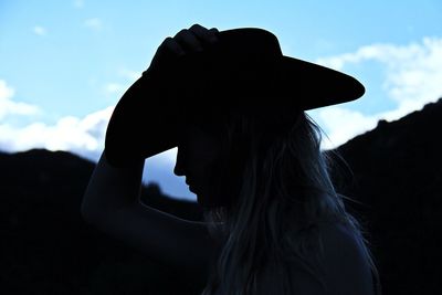 Close-up of silhouette woman against sky