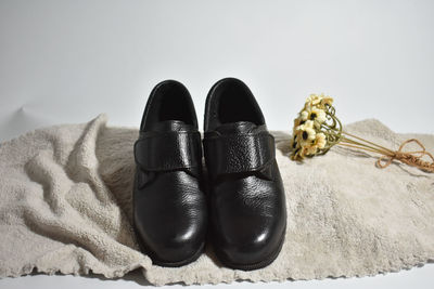 High angle view of shoes on floor against white background