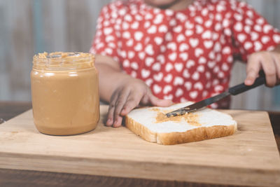 Close-up of woman holding ice cream on table