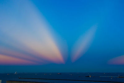 Scenic view of rainbow over sea against sky