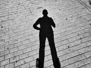 Shadow of man walking on footpath