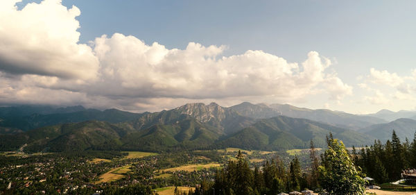 Panoramic view of trees and mountains against sky