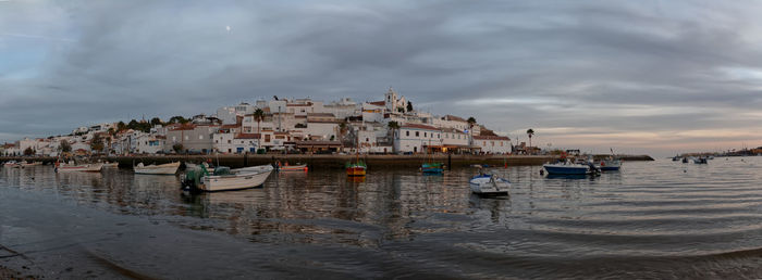 Panoramic view of sea and buildings against sky