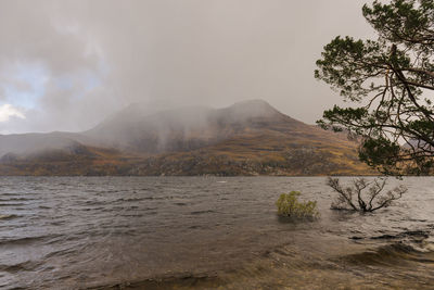 Scenic view of approaching storm rain over slioch in west scottish highlands 