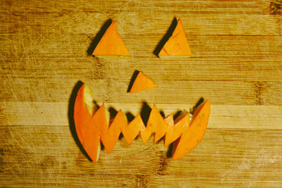 High angle view of carved pumpkin on wooden table