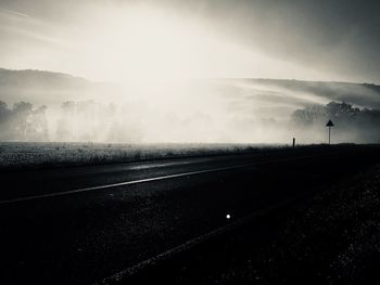 Road by landscape against sky