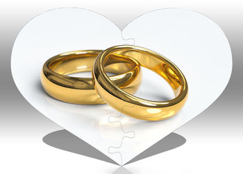 Close-up of wedding rings on heart shape