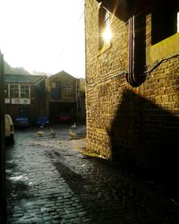 Wet illuminated city against sky