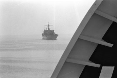 Ship sailing on sea against sky