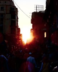 Crowd in city at sunset