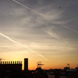 Silhouette built structures against sky