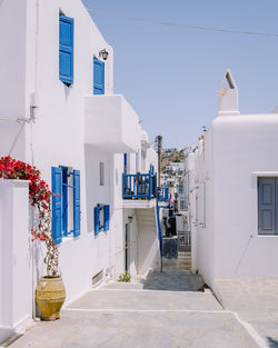 Street amidst buildings against clear blue sky