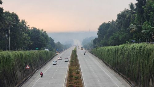 Rear view of man walking on road