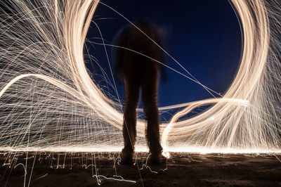 Man standing against light painting at night