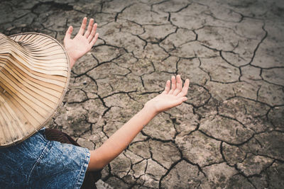 High angle view of girl gesturing on drought field
