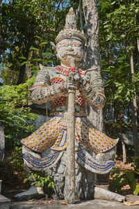 Statue of buddha against trees