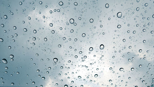 Full frame shot of raindrops on window