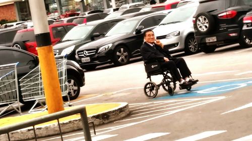 Man riding motorcycle on road in city