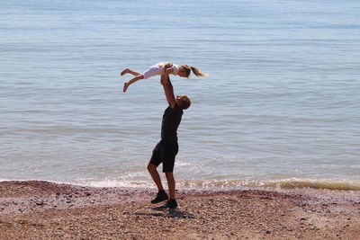 Man and his child on beach