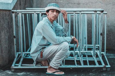 Portrait of young man sitting on seat