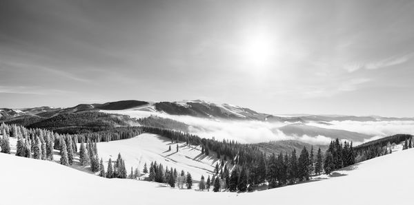 Scenic view of snow covered mountains against sky