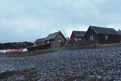 Houses on field against sky