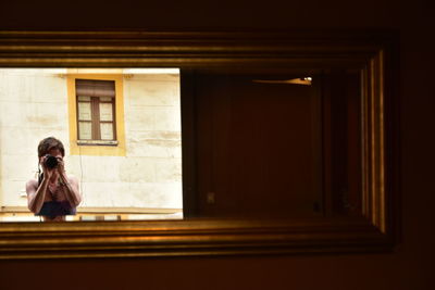 Woman looking through window