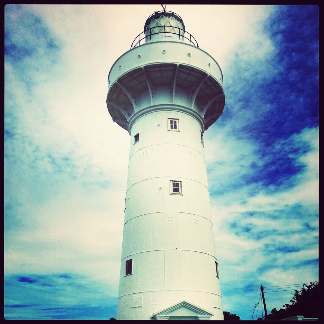 architecture, building exterior, built structure, low angle view, sky, lighthouse, tower, cloud - sky, guidance, cloud, transfer print, tall - high, direction, protection, auto post production filter, safety, blue, tall, cloudy, day