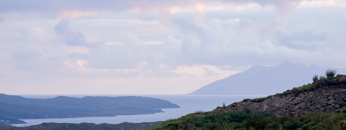 Scenic view of mountains and sea against sky