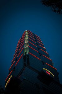 Low angle view of illuminated building against clear blue sky