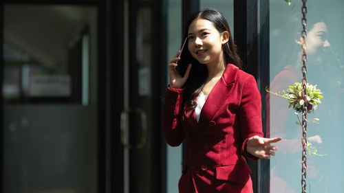 Young businesswoman talking on phone at office