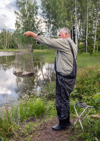 Rear view of man holding umbrella