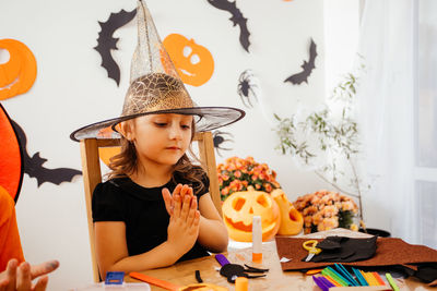 Girl wearing hat on table