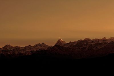 Scenic view of silhouette mountains against sky during sunset