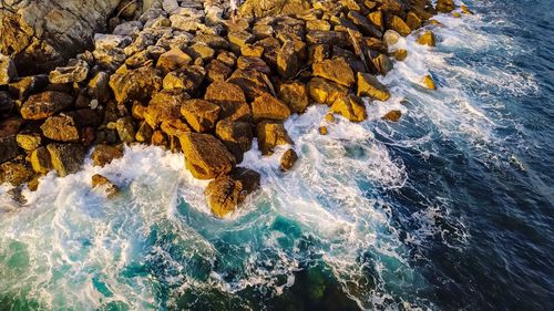 Aerial view of rocks in sea