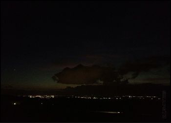 Scenic view of mountains against sky at night