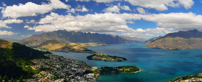 Panoramic view of sea and mountains against sky