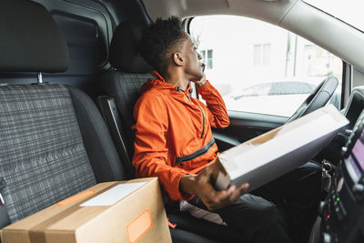 Full length of man sitting in car