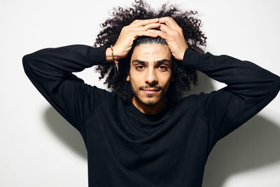 Portrait of young man against white background