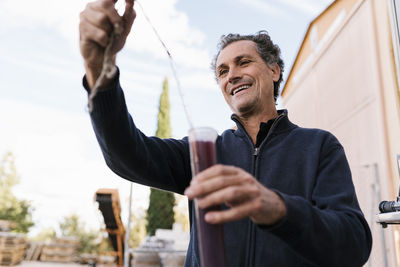 Portrait of man holding camera