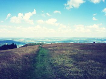 Scenic view of landscape against cloudy sky