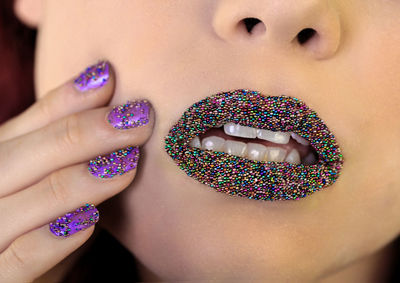 Cropped image of woman with sprinkles on lips