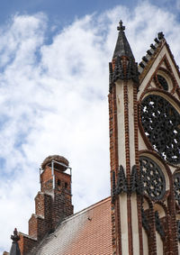 Low angle view of building against cloudy sky
