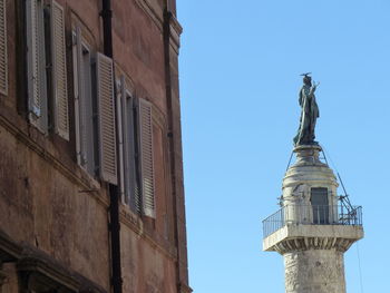 Low angle view of statue against clear blue sky