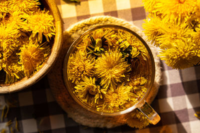 Dandelion flower healthy tea in glass cup on table. herbal medicine delicious tisane tea from with