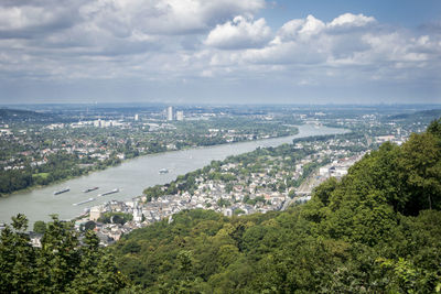 High angle view of townscape by sea against sky