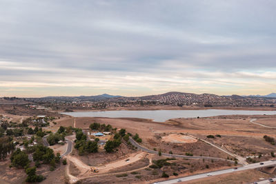 Road leading to reservoir in drought-stricken san diego. aerial panorama.