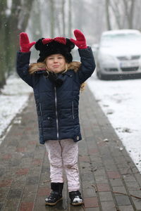 Portrait of smiling girl standing in snow